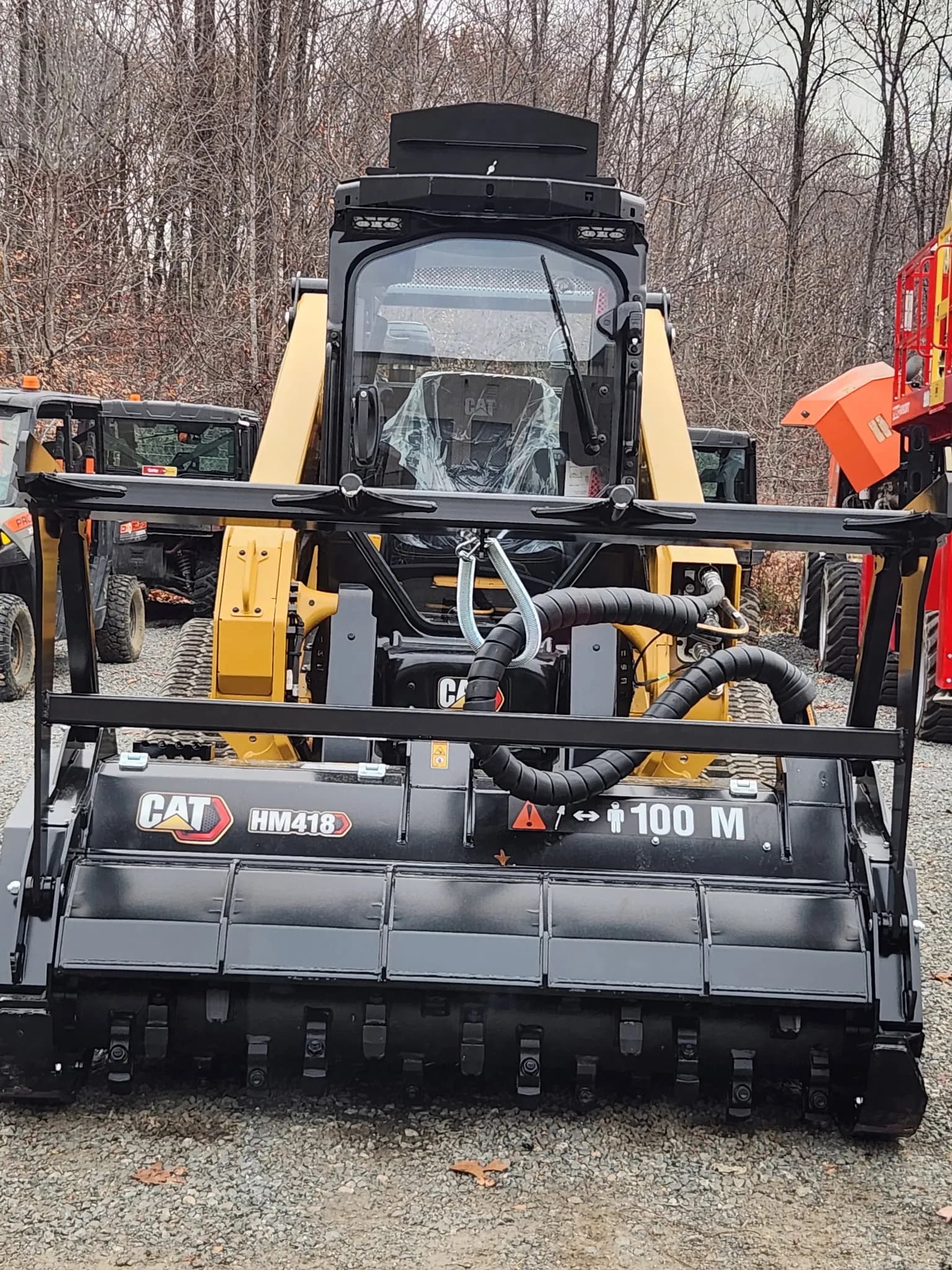 Tracked loader fitted with a forestry mulching attachment